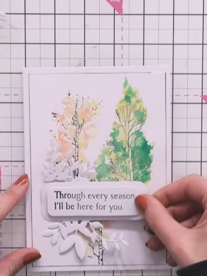 Step 10: Adhere the sentiment banner to the inside of the card as a focal point. Position the white foliage adornment d