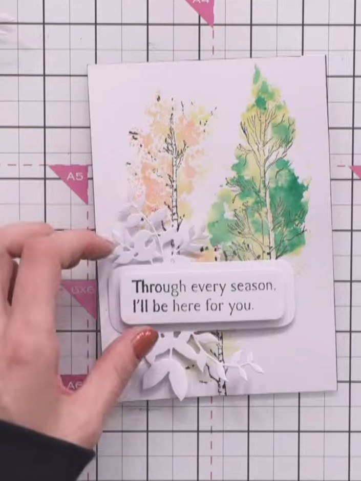 Step 9: Adhere the stamped tree card to the front of the larger card blank using a tape pen or glue. Position it centr