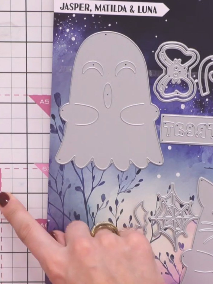 Step 1: Select the large ghost die (the mummy character) from the Jasper, Matilda & Luna die set. Place it on your cut