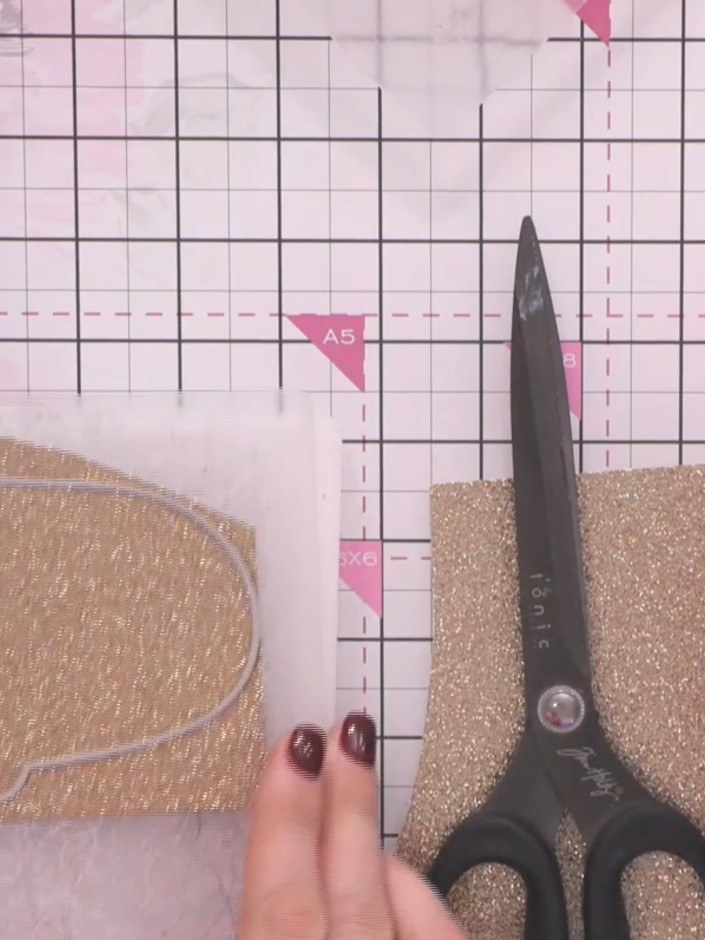 Step 2: Die cut the base layer of the mummy ghost character using gold glitter cardstock. Run the cardstock and die th