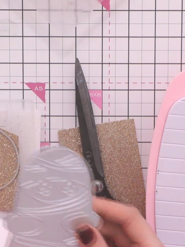 Step 3: Cut the decorative mummy bandage layer from the gold sparkle cardstock using scissors. This will create a shim