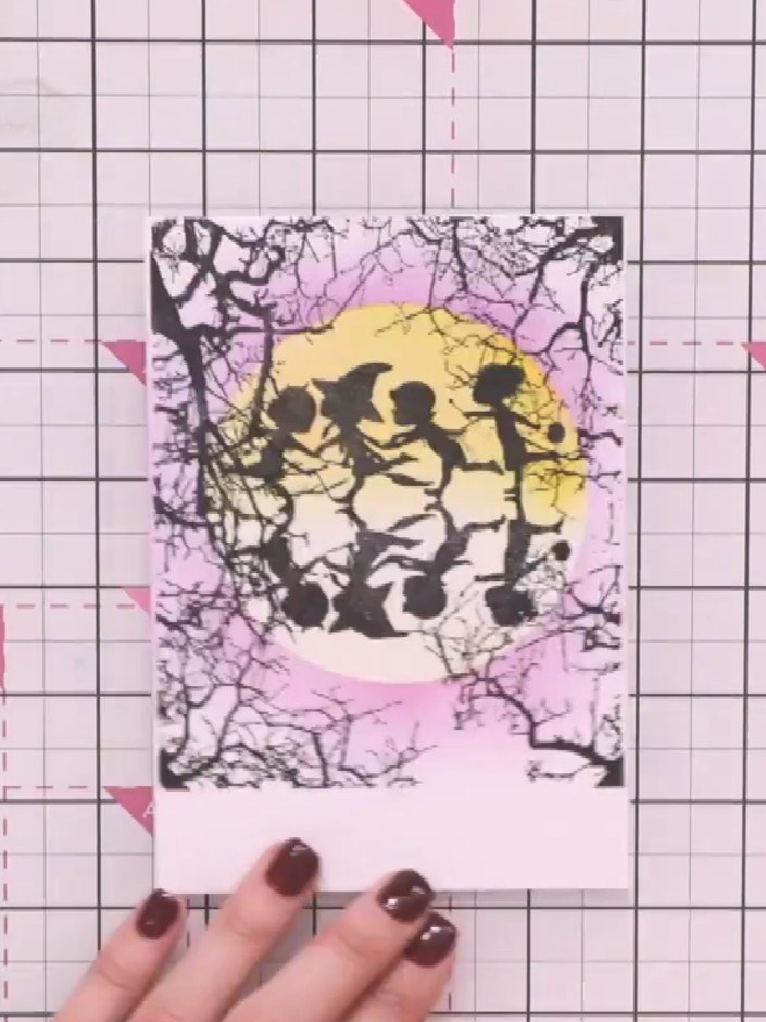 Step 10: Stamp a sentiment such as 'Trick or Treat' from the stamp set underneath the moon and figures design to comple