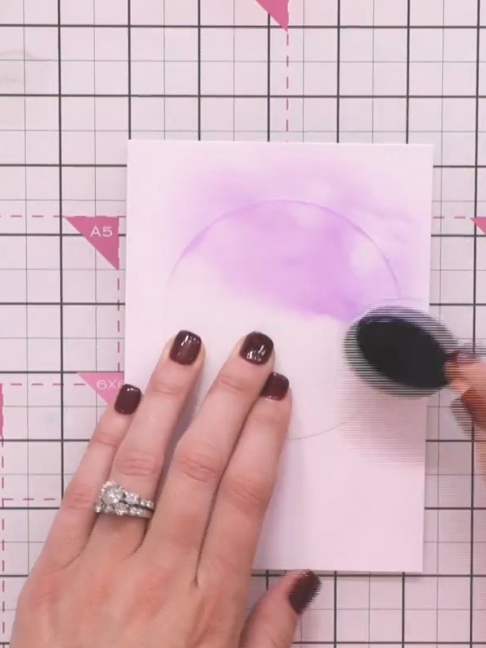 Step 3: Apply purple ink through the circular aperture of the stencil using a blending brush. Twist the brush gently i