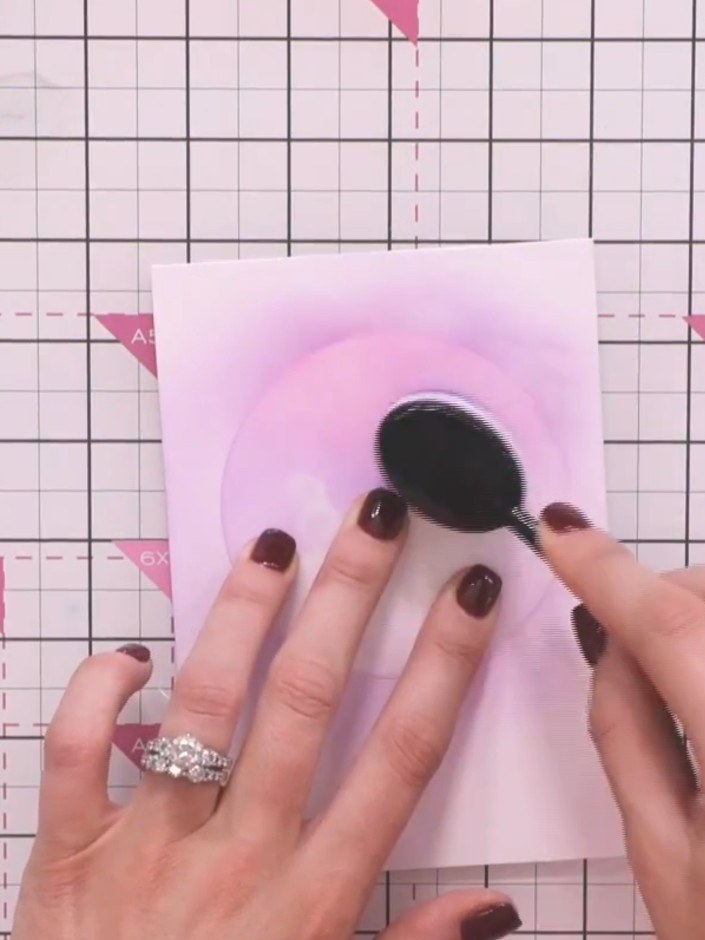 Step 4: Reposition the stencil on the pink card and blend pink ink around the moon shape using a blending tool. Apply 