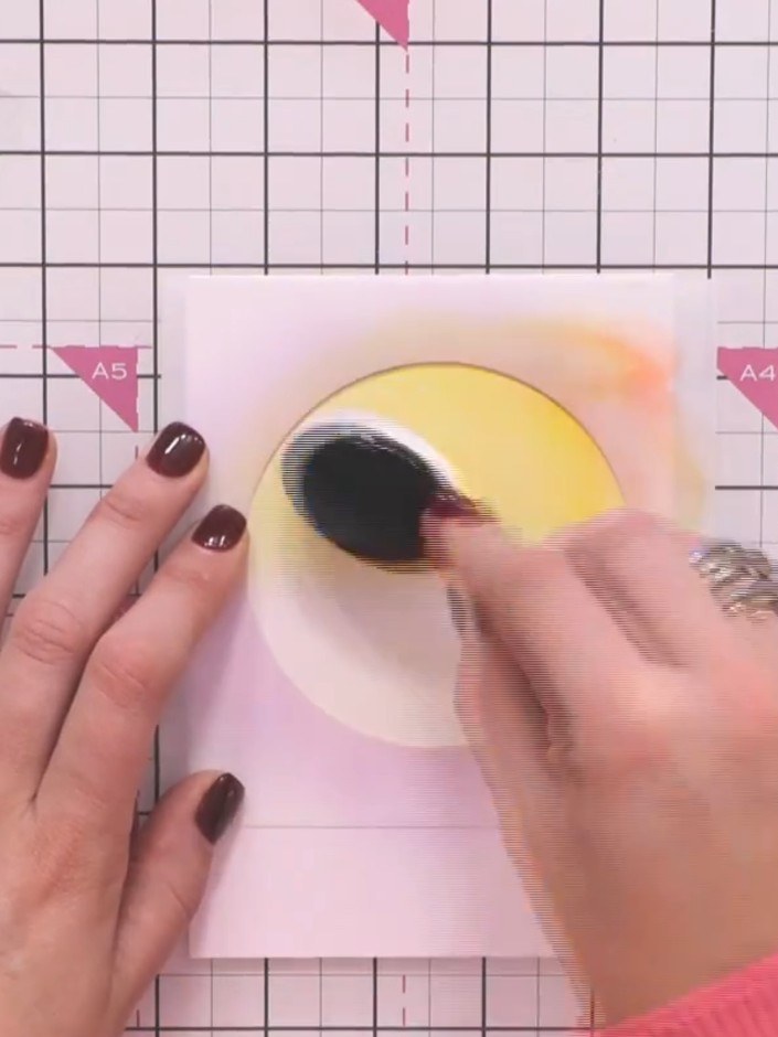 Step 7: Apply a touch of orange ink around the edges of the yellow circle to enhance the atmospheric effect and create
