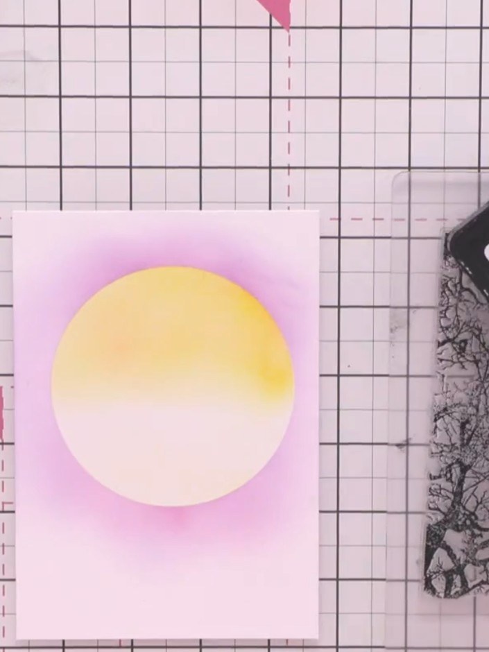Step 8: Remove the stencil from the card. Using black ink, stamp the foliage frame stamp around the edges of the moon 