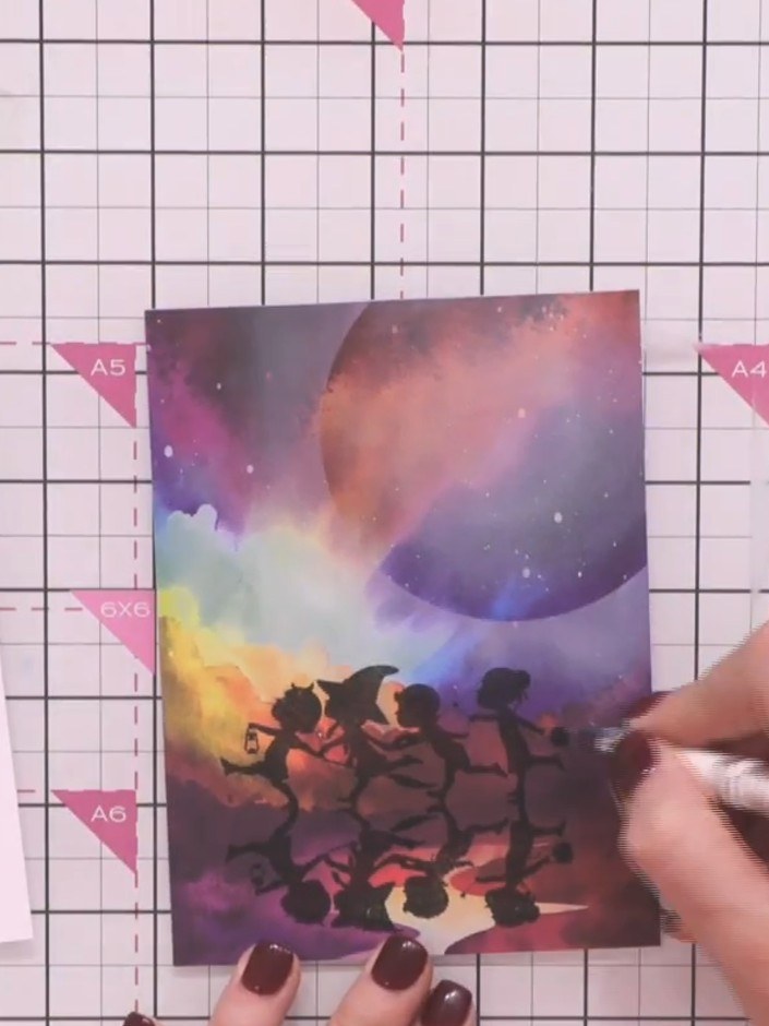 Step 7: Using a white gel pen, add highlights to the tops of the silhouette figures and any raised elements to create 