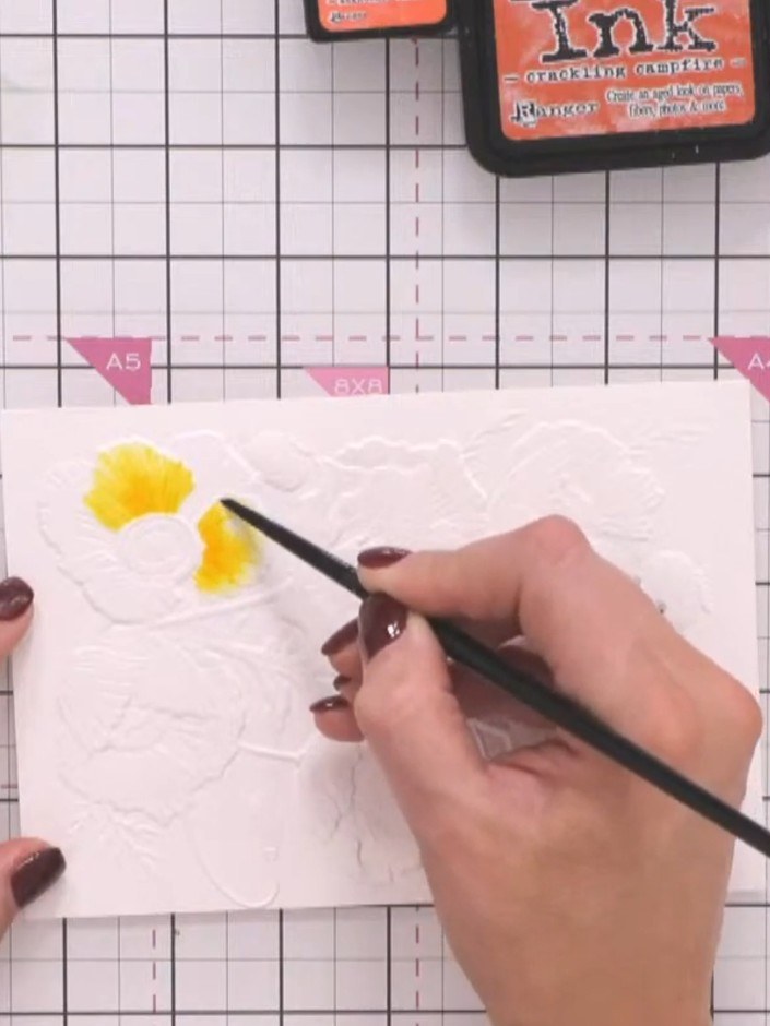 Step 7: Move to a petal that is not adjacent to the one you just coloured. Pick up yellow ink with your brush and appl