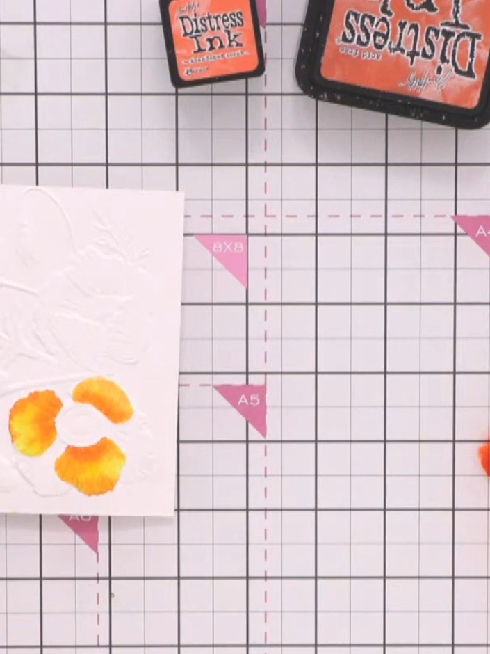 Step 8: While the water is still wet on the petal, add a second colour (such as deep red or pink) into the same area. 