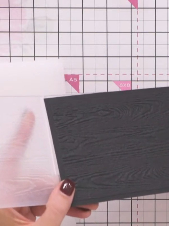 Step 2: Run the black cardstock through your die-cutting machine with the Driftwood embossing folder to create a wood 