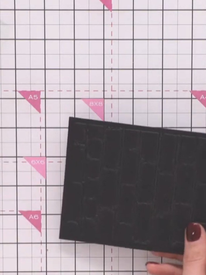 Step 7: Run the brick embossing folder through your die-cutting machine with a piece of black cardstock to create the 