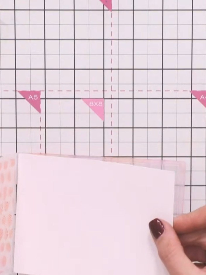 Step 6: Spray the embossing folder lightly with water, then place your card inside the folder. Run the folder through 