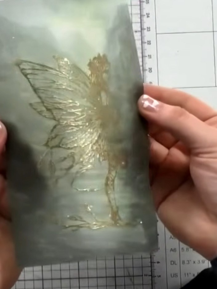 Step 11: Carefully tear or rip the vellum around the fairy image to create a soft, organic edge. Hold the vellum with b