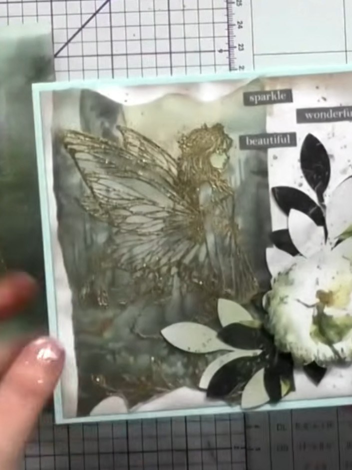 Step 12: Layer the heat embossed vellum piece over a white card base to enhance and showcase the deep gold embossing ef
