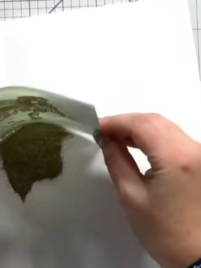 Step 7: Tap away any excess embossing powder back into the container for reuse. Gently shake the vellum piece to remov