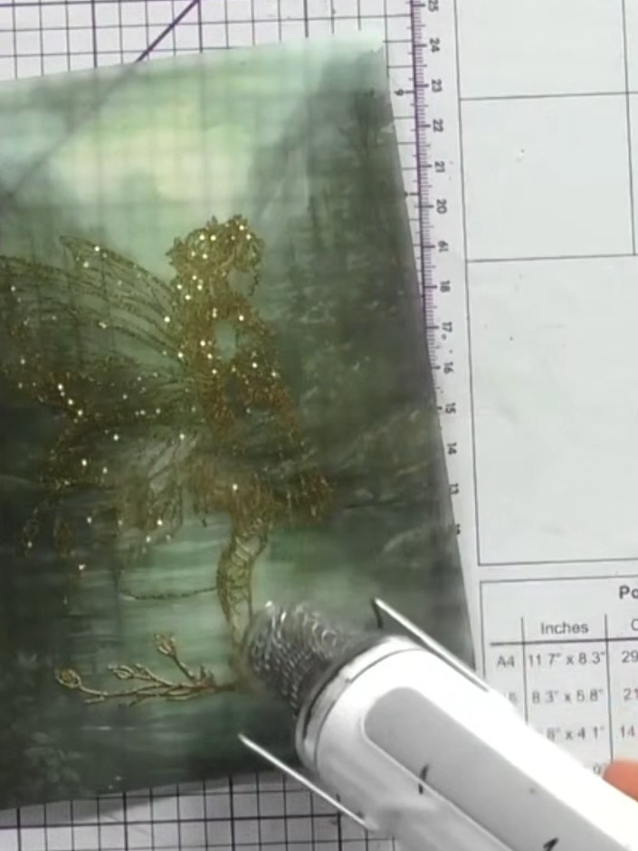 Step 9: Hold the heat gun over the embossed image, moving it gently until the gold embossing powder melts and fuses to