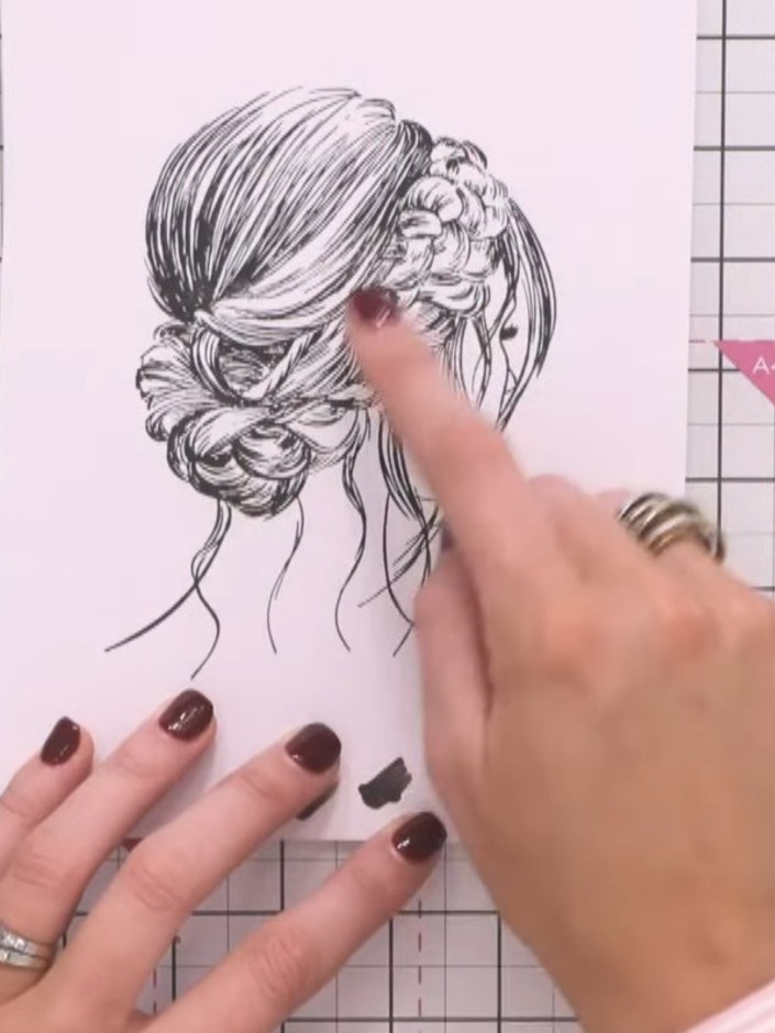 Step 4: Select a marker pen in a hair colour shade. Follow the hair lines in the stamp design, feathering the colour o