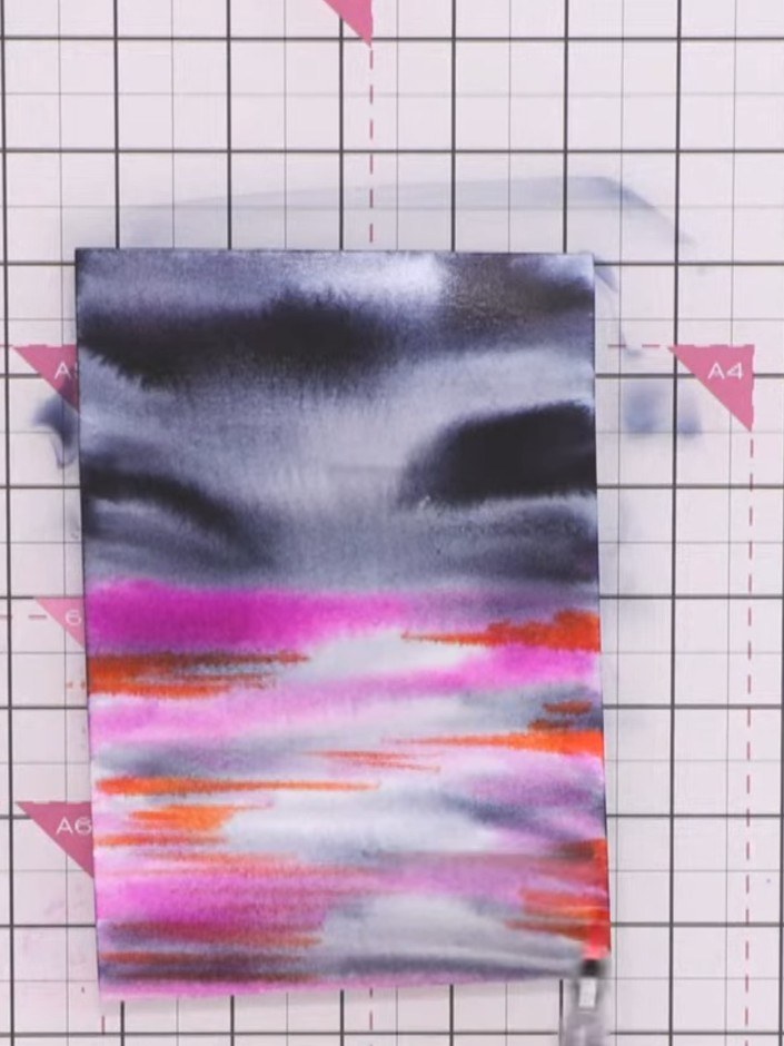 Step 6: Use a clean, wet brush to move the bright colours around and blend them together on the card, creating smooth 