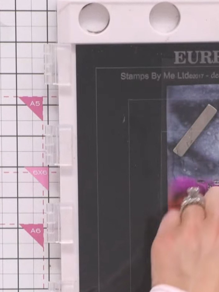 Step 3: Stamp the reflection element from the set in black ink below the swans to create water ripples. Position the s