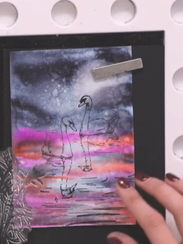 Step 5: Stamp the foliage design along the bottom left corner and lower left side of the black card mount to frame the