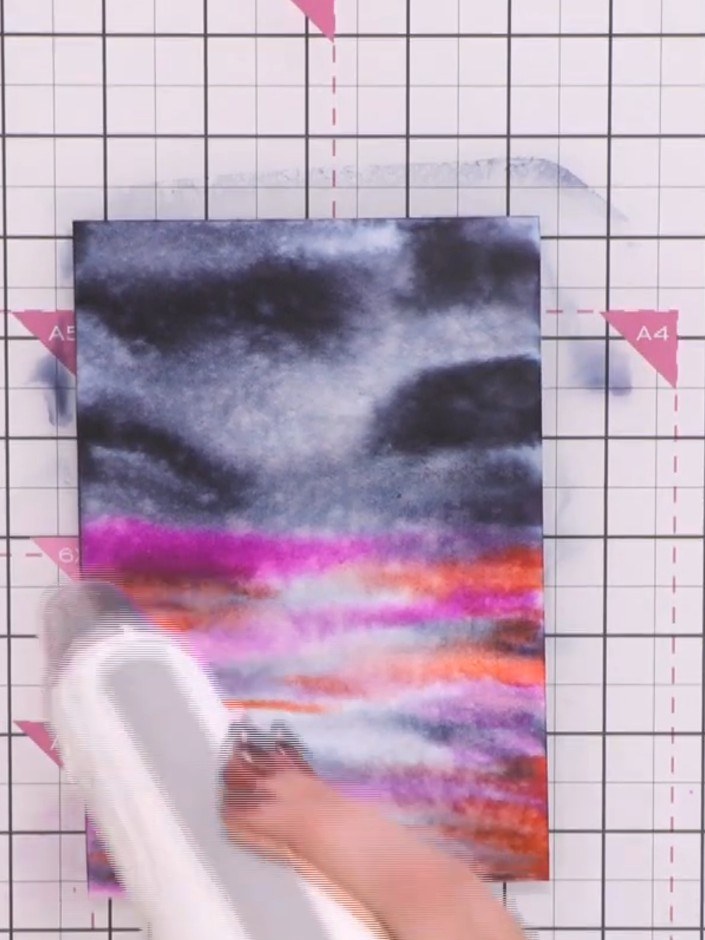 Step 7: Create a moon by wetting your brush and painting a circular shape in the sky area. Use damp tissue to lift out