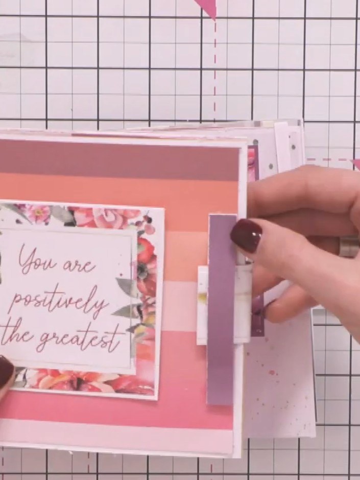 Step 16: Decorate the closure and album exterior with flowers, embellishments and toppers from your kit. Layer the deco