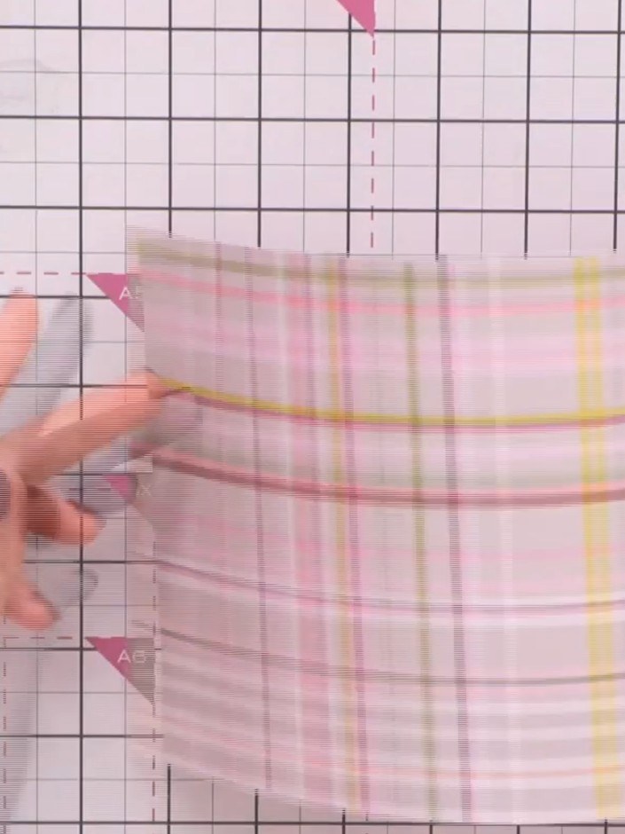Step 6: Take your first sheet of patterned paper and fold it in half. Score and fold additional flaps along the edges 