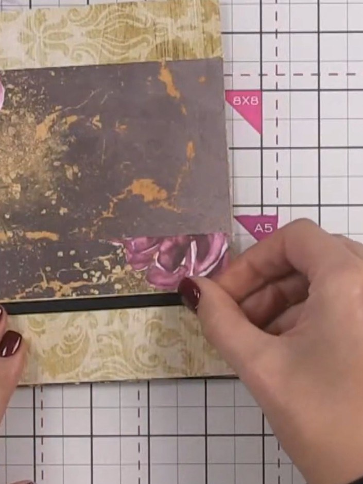 Step 10: Optional: fussy cut decorative elements from the patterned paper collection and layer them over the pocket edg