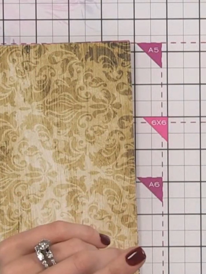Step 3: Fold the 12 by 8 inch decorative paper in half lengthways, with the patterned side facing outwards. Crease the