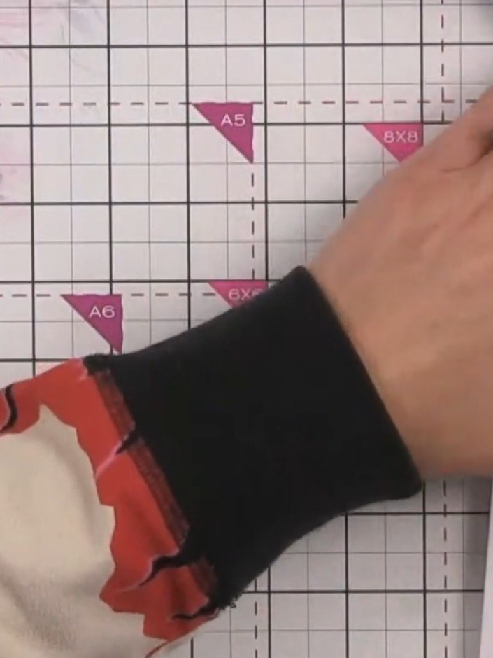 Step 6: Using your scissors or craft knife, carefully cut away the excess paper between the two score lines on the pat