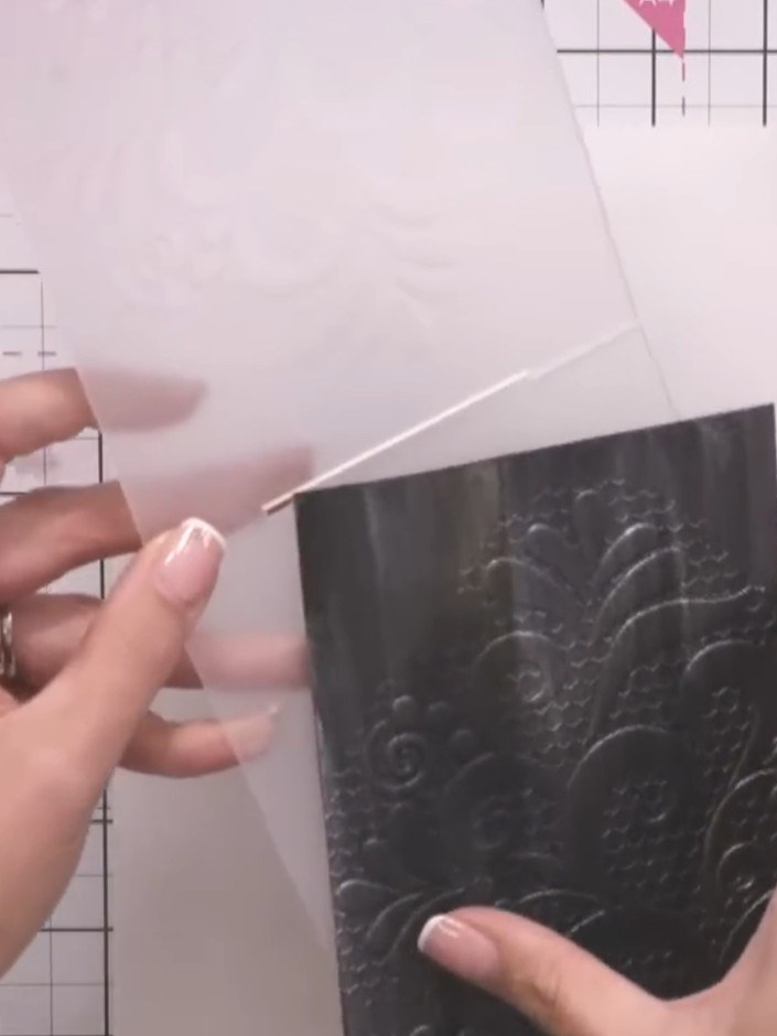 Step 7: Carefully peel away and remove the embossing folder from your black card to reveal the raised honeycomb swirl 