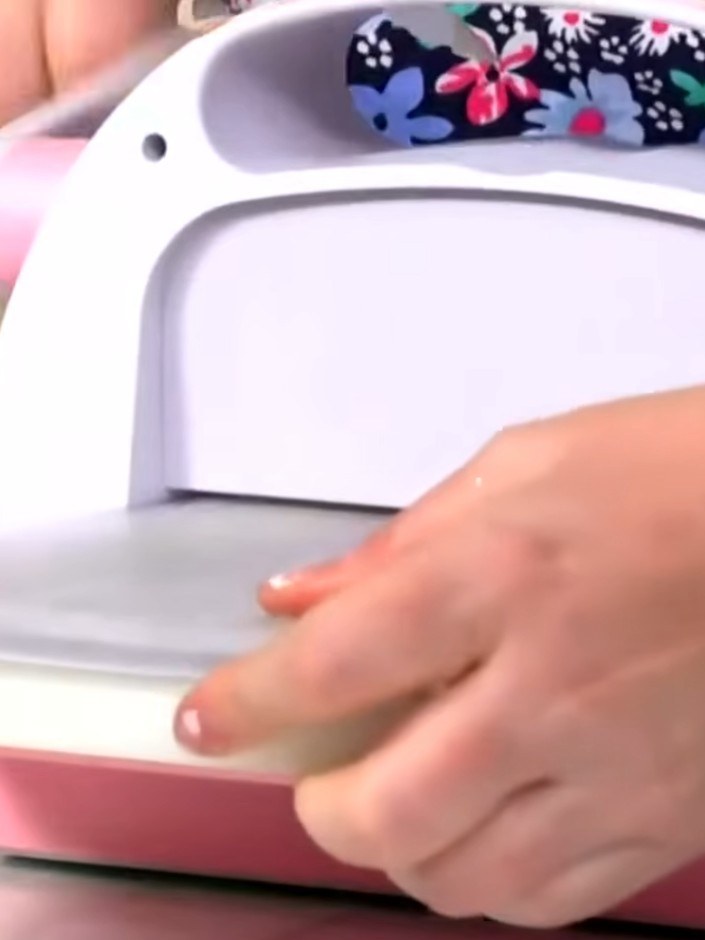 Step 2: Close the embossing folder with your card inside and run it through your die-cutting machine to emboss the des