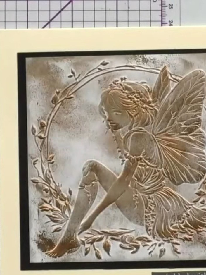 Step 7: Allow the ink to dry completely. The embossed fairy design should show through with gold and bronze metallic t