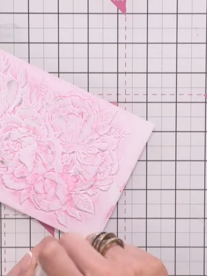Step 10: Use an embossing powder brush to gently sweep away any excess embossing powder from between the embossed flora