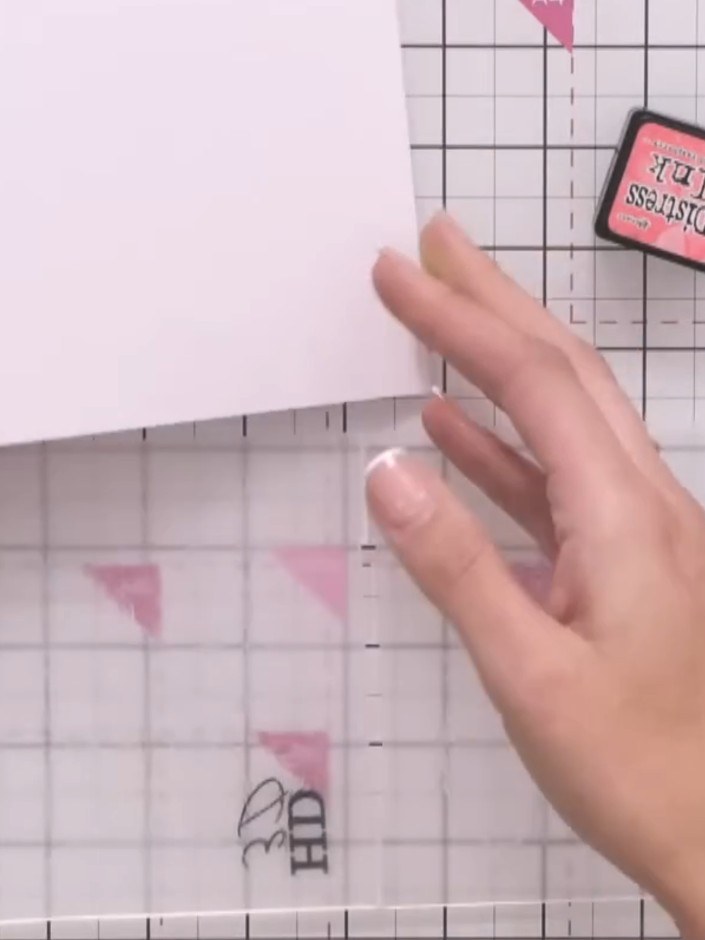 Step 3: Place your white cardstock into the prepared embossing folder. Ensure the cardstock is positioned correctly wi