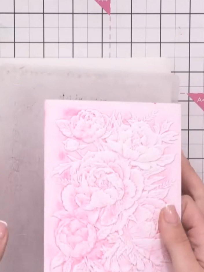 Step 7: Wipe the embossed pink floral panel with an anti-static bag to prevent moisture and ensure clean embossing. Th