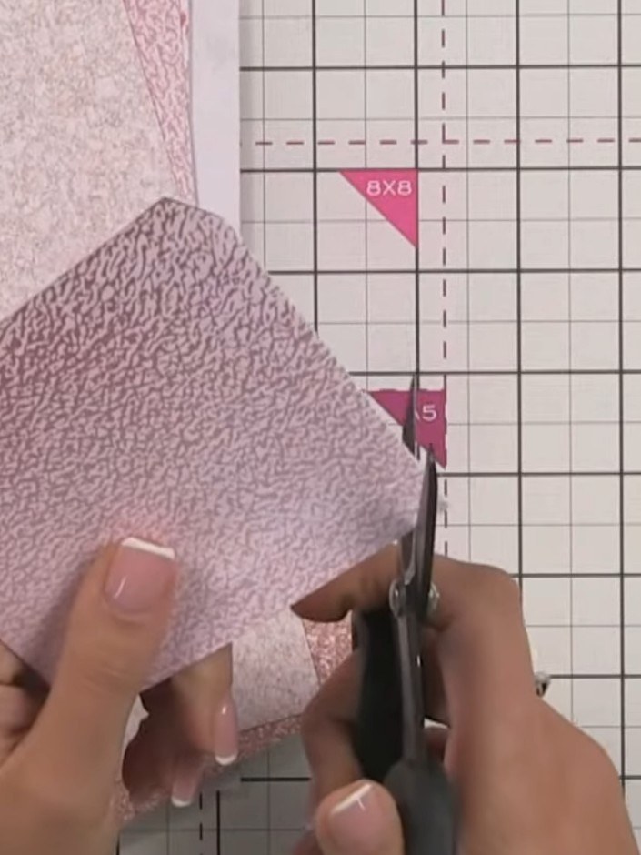 Step 10: Trim away the bulk from the pocket corners using scissors. Cut away one hinge section on each side of the pock