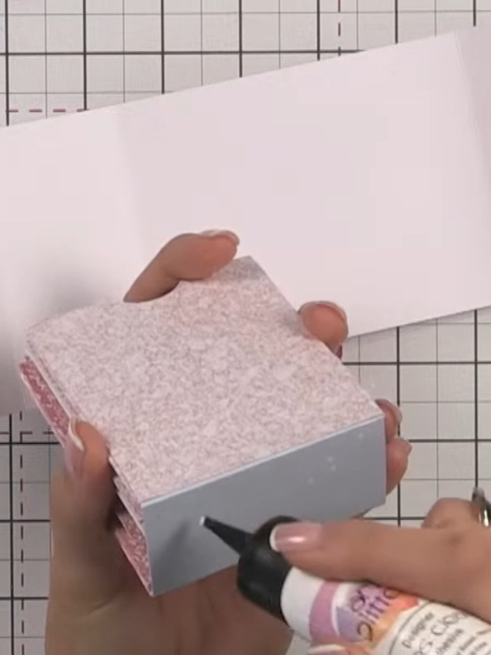 Step 13: Apply glue to the completed hinge system with all pockets attached and adhere it into the base of your album b