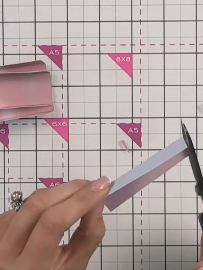 Step 6: Trim away the bulk from the corners and edges of each pink ribbon hinge piece using scissors to reduce thickne