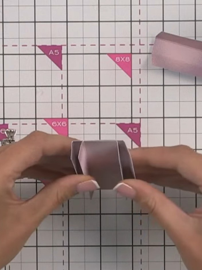 Step 7: Glue the pink hinge pieces inside each other in size order, starting with the largest. Space them evenly to cr