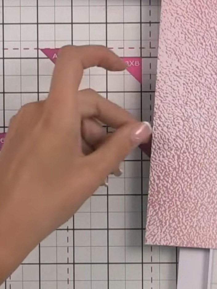 Step 8: Corta seis piezas de papel decorado de 8x8 por la mitad, a 4 pulgadas, para crear las bases de tus bolsillos. Use the paper trimmer t