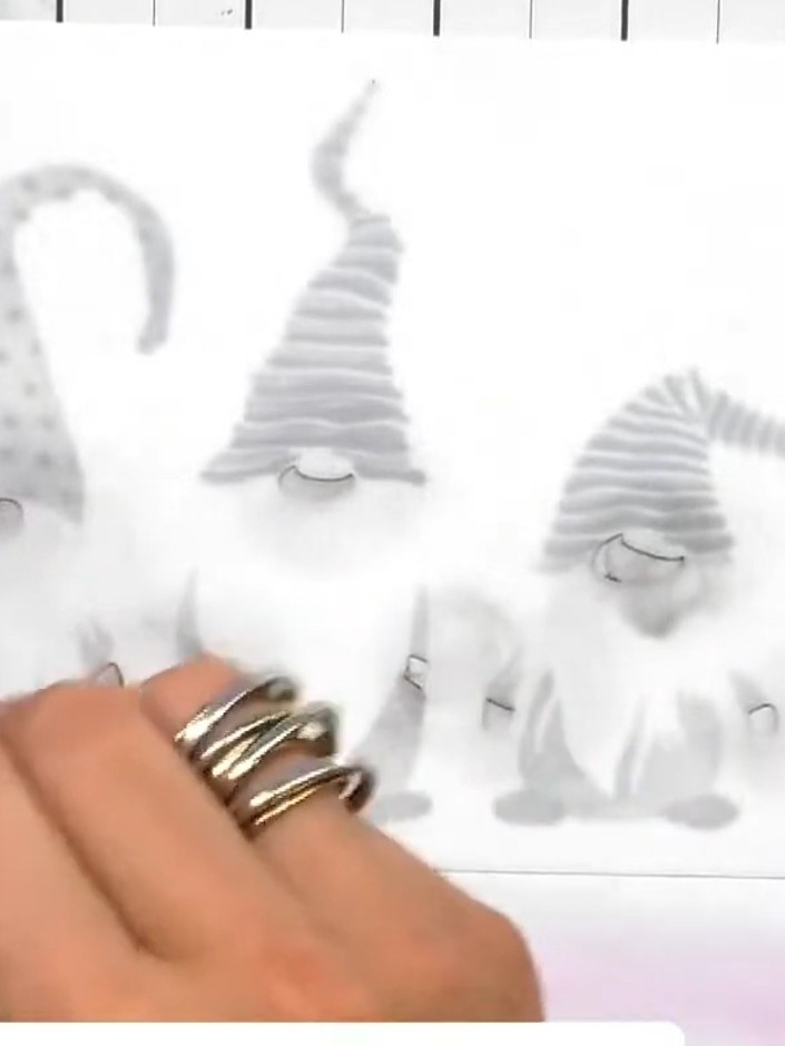 Step 4: Apply the third stencil layer to add the halo details on the gnomes' noses and hands using light-to-medium gre