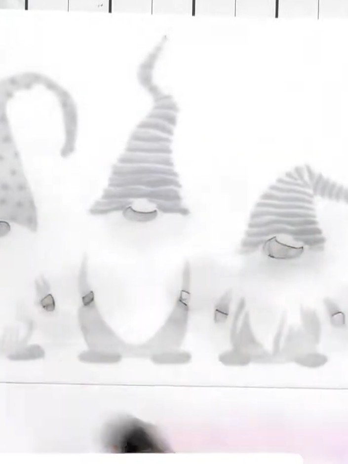 Step 5: Stamp the gnome outlines in black ink onto white cardstock, carefully lining them up over the previously stenc