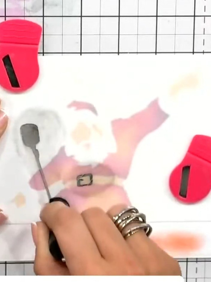 Step 5: Apply the fourth stencil over the Santa image and use the grey ink pad with a blending tool to add texture and