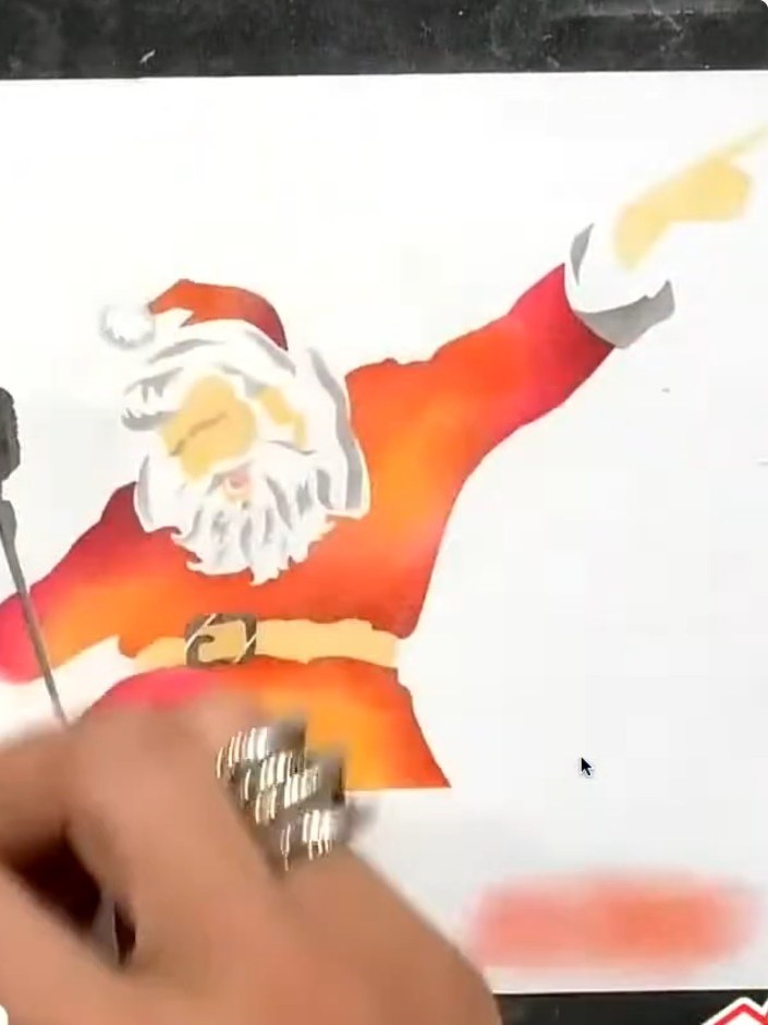Step 6: Stamp Santa's outline in black ink onto the white card, carefully lining it up over all the stencilled colour 