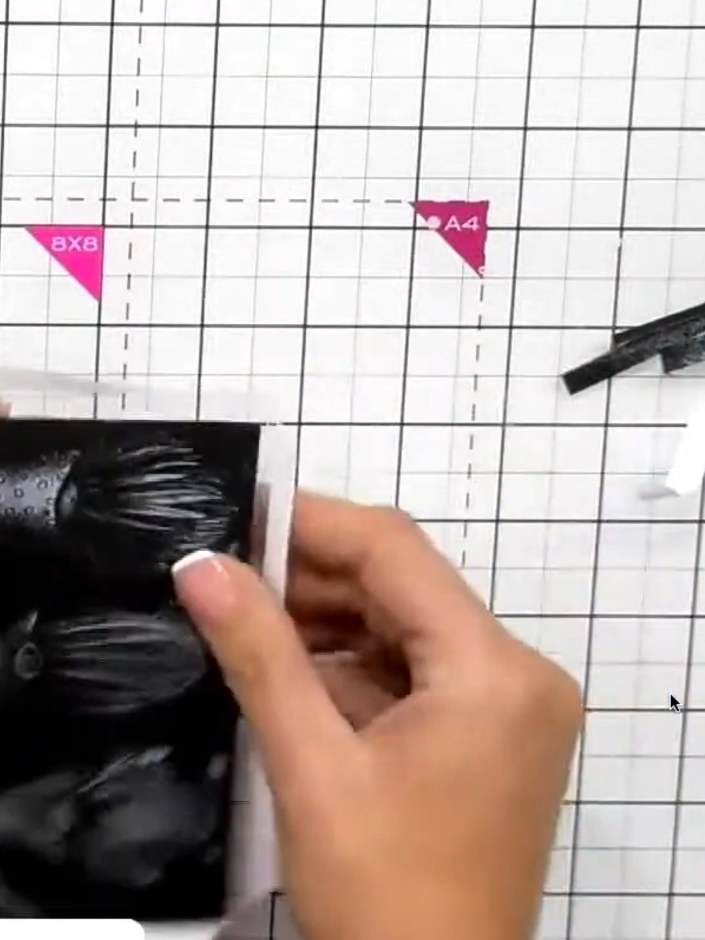 Step 4: Peel back one side of the self-adhesive tape from your window piece. Press the exposed adhesive side down firm