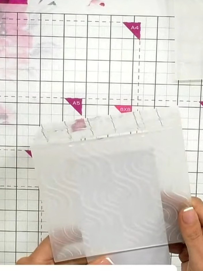 Step 2: Run the white card through your die-cutting machine with the embossing folder to emboss the top section with t