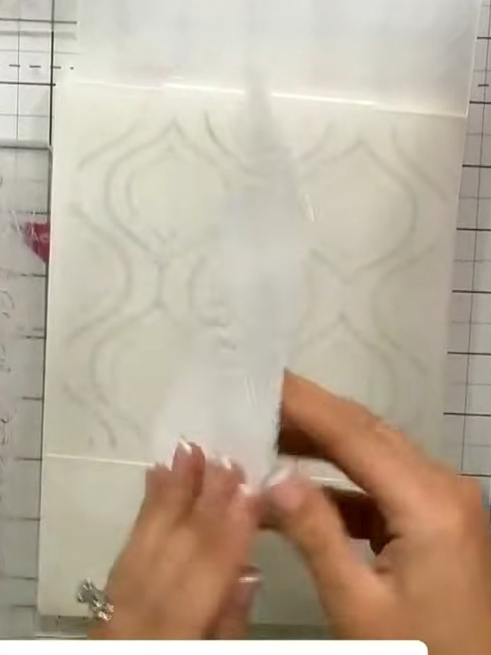 Step 3: Position the second embossing folder (the floral design) at the bottom of the card, slightly overlapping where