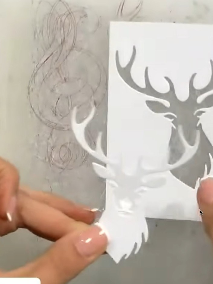 Step 3: Mount the white stag head die-cut onto black cardstock to create a backing layer. This prevents the stag from 