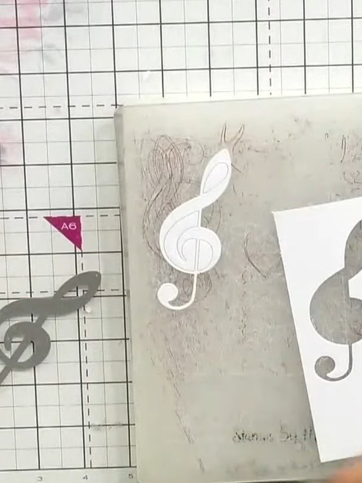 Step 1: Stamp the treble clef detail stamp onto white cardstock at an angle using white ink. Position the stamp diagon